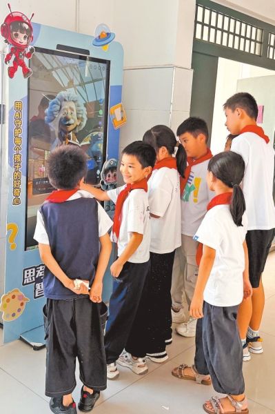 郑州航空港科技一街小学,学生围着“好奇窗”向“爱因斯坦”提问。 郑州航空港科技一街小学,学生围着“好奇窗”向“爱因斯坦”提问。